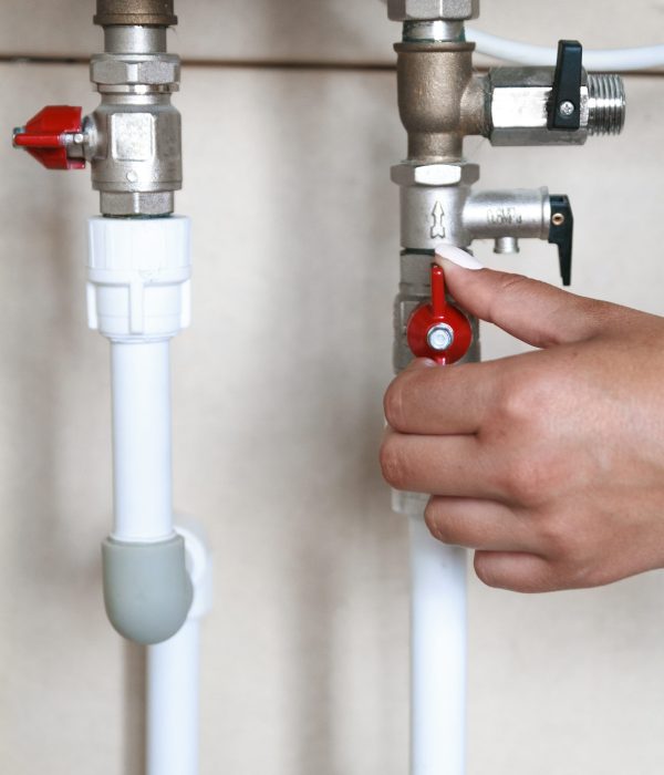 Woman's hand closes the valve. Saving Water Consumption Concept